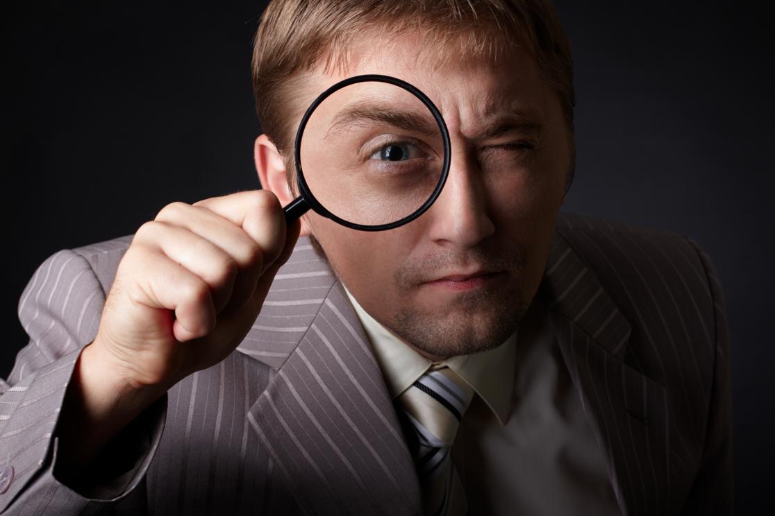 A man looking with a magnifying glass